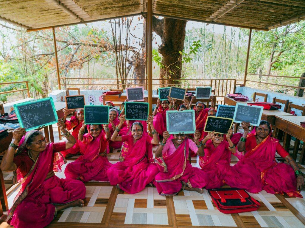 Pupils holding up their slates from The School of Second Chances by Arvind Patwal, a Regional Grant Award project documenting elderly women at a grandmothers' school in India.