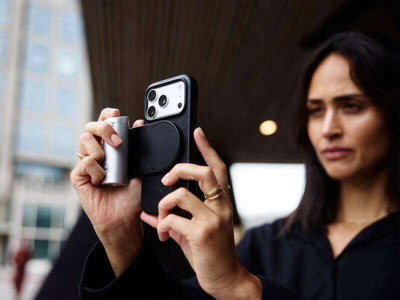 The silver LUX grip connects by Bluetooth, lasts about 1,000 shots per charge, and works with iPhones back to the iPhone 12.