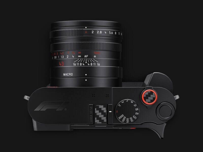 Front view of the Q3 43 Formula 1 Edition showing the APO-Summicron 43mm f/2 lens, the Formula 1 logo on the top plate and the carbon inlay soft release button with its red rim.