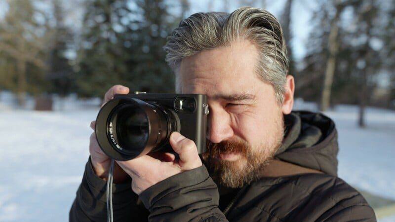 The Pixii Max in use outdoors in winter, raised to the eye.