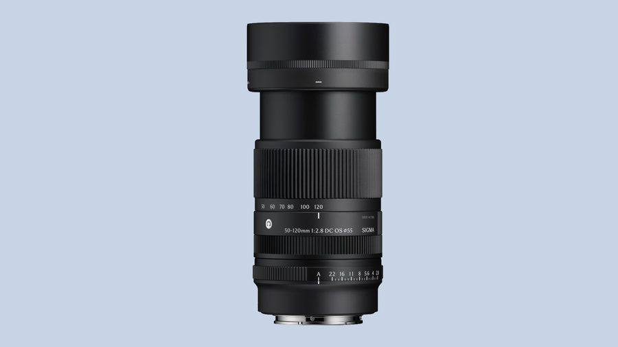 The Sigma 50-120mm F2.8 DC OS Contemporary standing upright with its hood fitted, showing the focal length scale and the aperture ring.