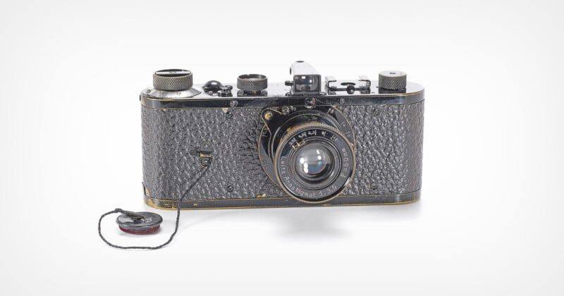The Leica 0-Series No. 103 of 1923, with its Leitz Anastigmat 50mm lens and lens cap on its string, photographed for the eighth Wetzlar Camera Auctions catalogue.